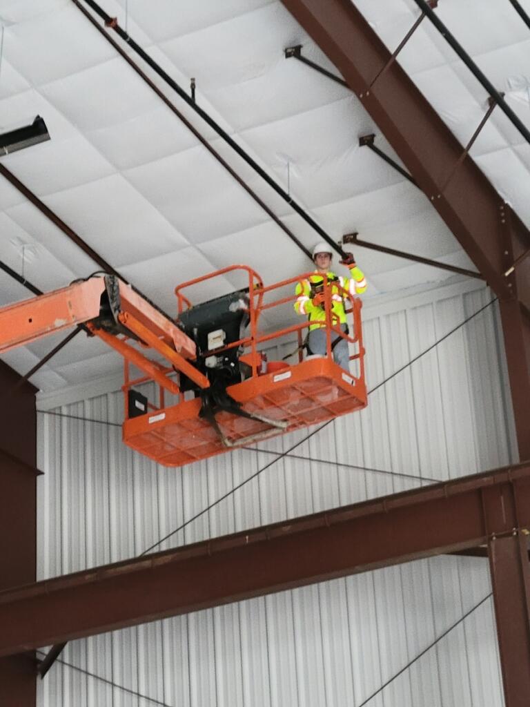 Jeffrey Markle of Northwatch Fire Protection working from an aerial lift on a sprinkler system
